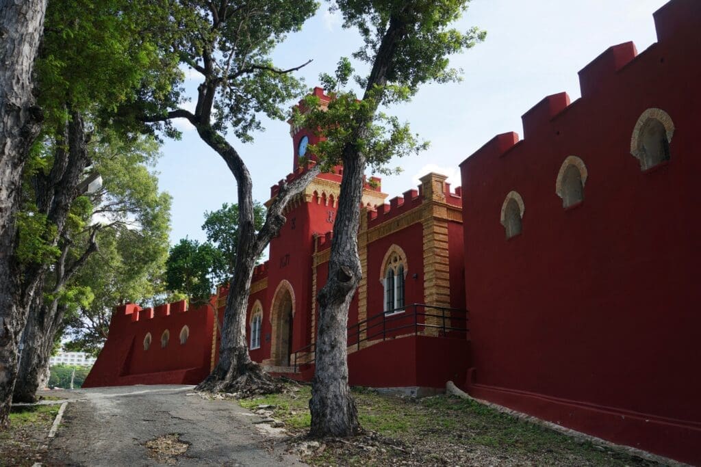 A red building with a tree in front of it
